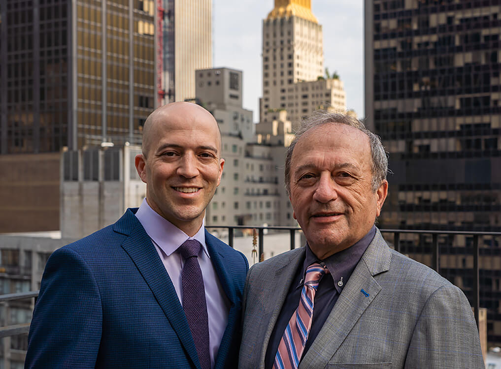 Drs. Matthew and Sheldon Nadler with the NYC skyline in the background